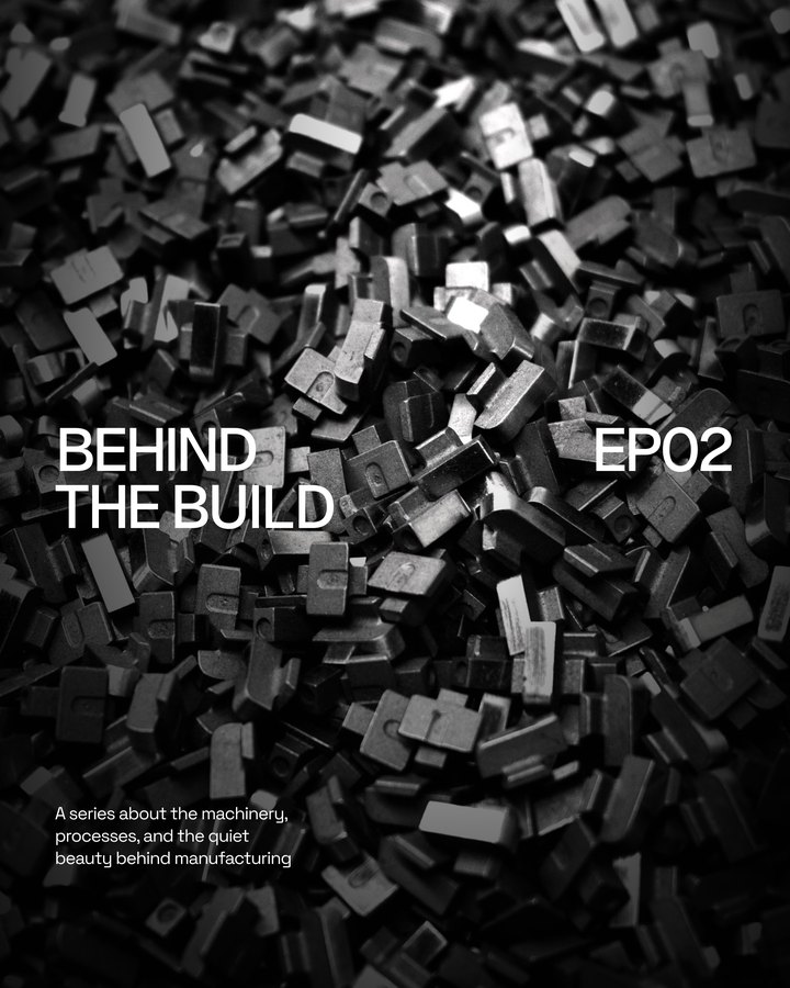 Title card reading Behind the Build, EP02: a series about the machinery, processes, and the quiet beauty behind manufacturing, over a pile of metal parts
