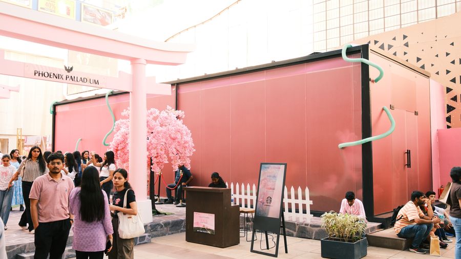 Visitors outside the pink exhibit pavilion in the mall atrium