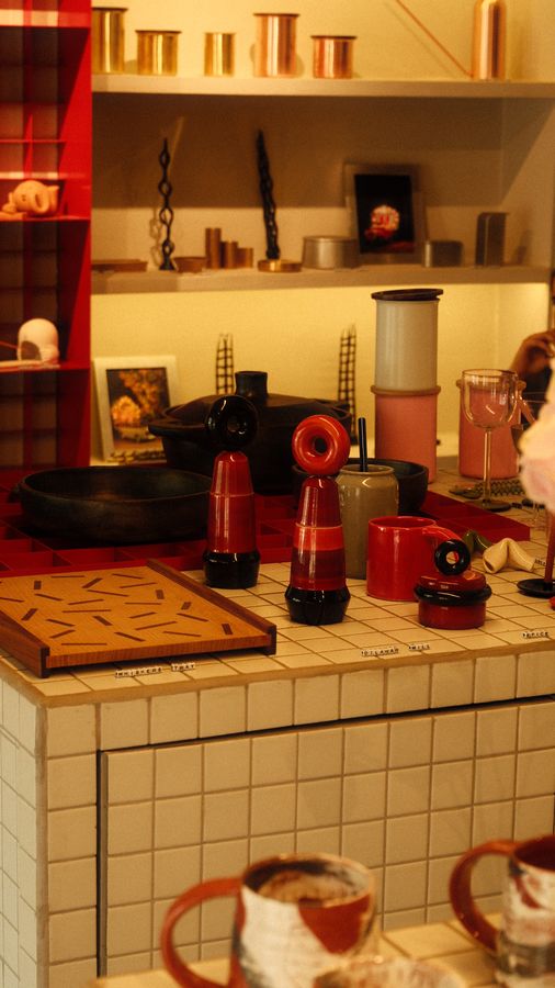 Shelves of red and black lacquerware above a tiled counter
