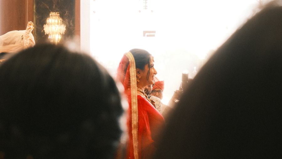 The bride glimpsed between the heads of guests
